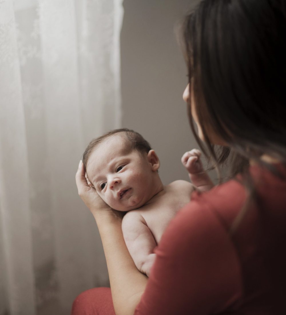 mother-holding-adorable-little-baby-min
