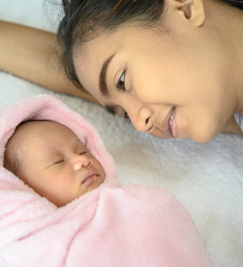 mother-looked-newborn-baby-bed-min